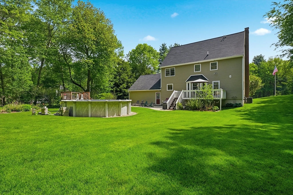 9 Fazio Farm Road Georgetown, MA 01833 - Photo 37 of 42 a front view of a house with a yard