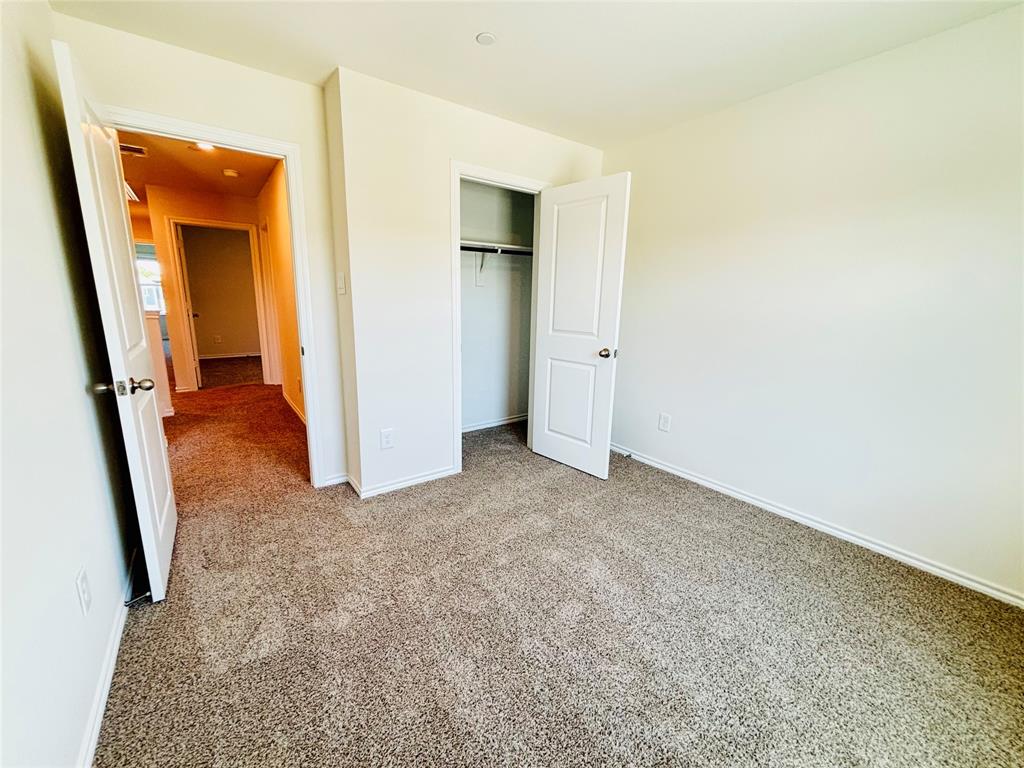 120 Redwood Road Princeton, TX 75407 - Photo 18 of 24 Bedroom featuring neutral tone carpeting and light-colored walls
