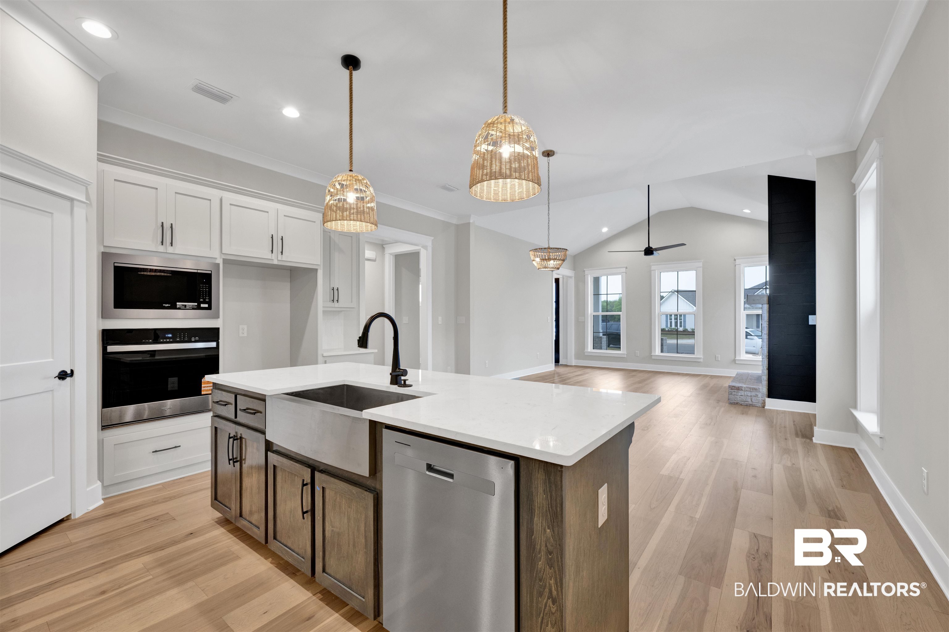 27382 Patch Pl Loop Daphne, AL 36526 - Photo 29 of 31 Kitchen featuring stainless steel appliances, dual tone cabinets, light wood-style flooring, light stone counters, and vaulted ceiling