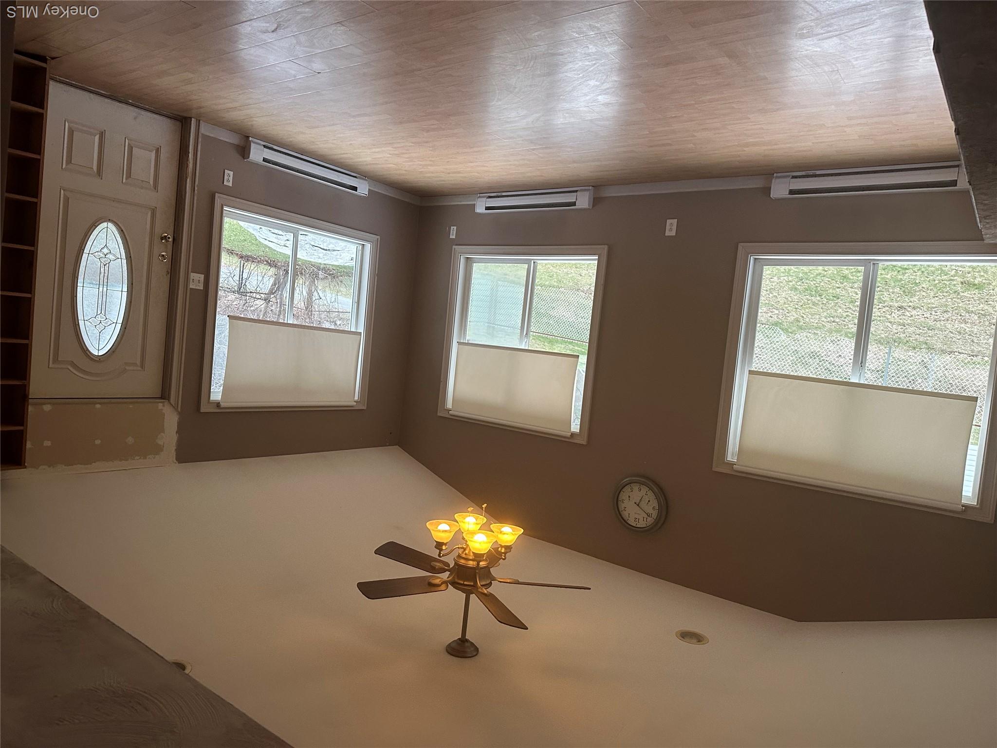 12 Bruce Street Newburgh, NY 12550 - Photo 2 of 8 a view of an empty room with window and wooden floor