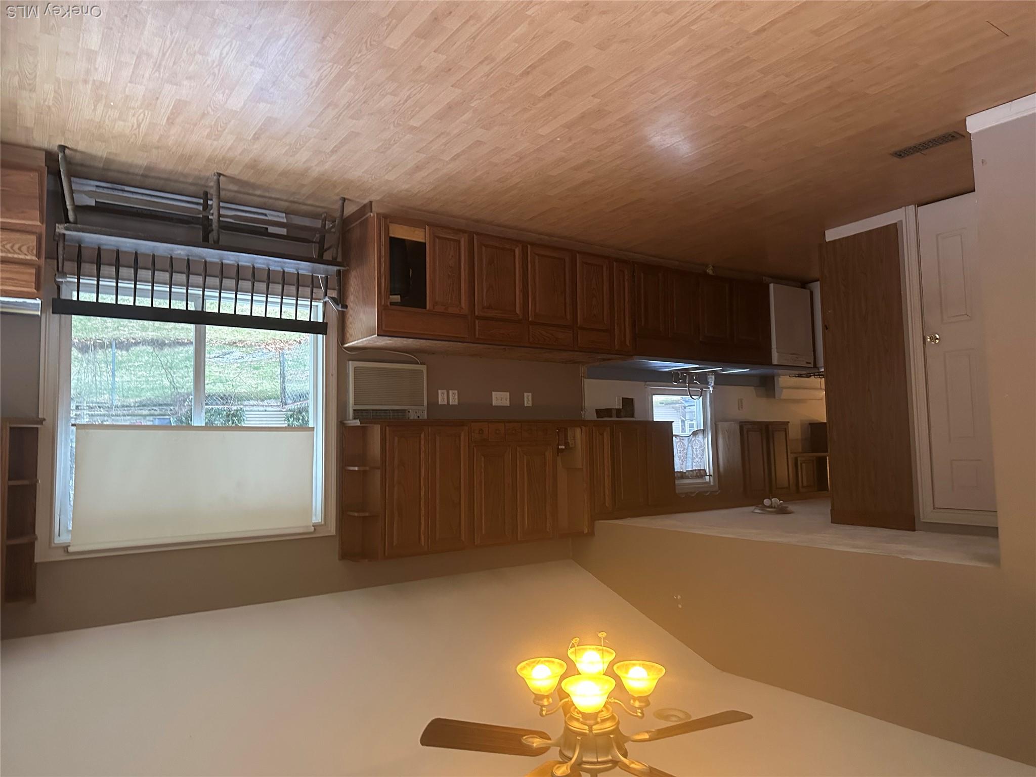 12 Bruce Street Newburgh, NY 12550 - Photo 3 of 8 a kitchen with kitchen island a large window a sink stainless steel appliances and cabinets