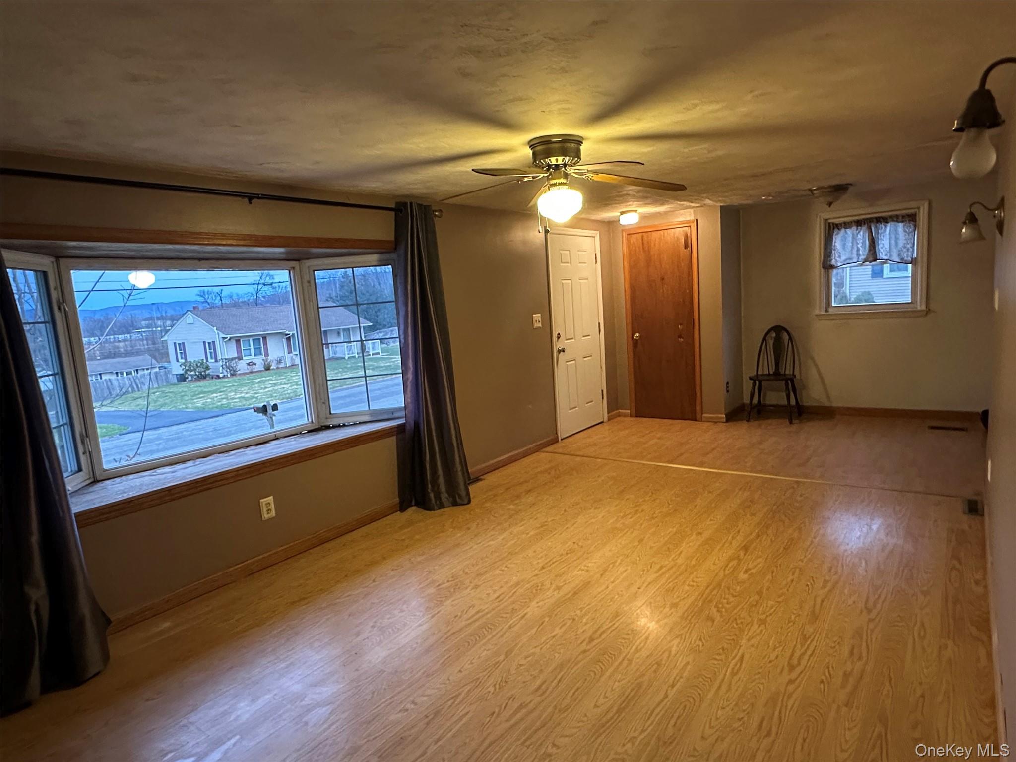 12 Bruce Street Newburgh, NY 12550 - Photo 4 of 8 a bedroom with wooden floor and window