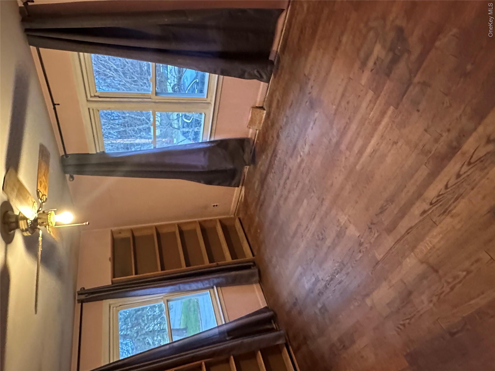 12 Bruce Street Newburgh, NY 12550 - Photo 6 of 8 a view of an empty room with wooden floor and windows