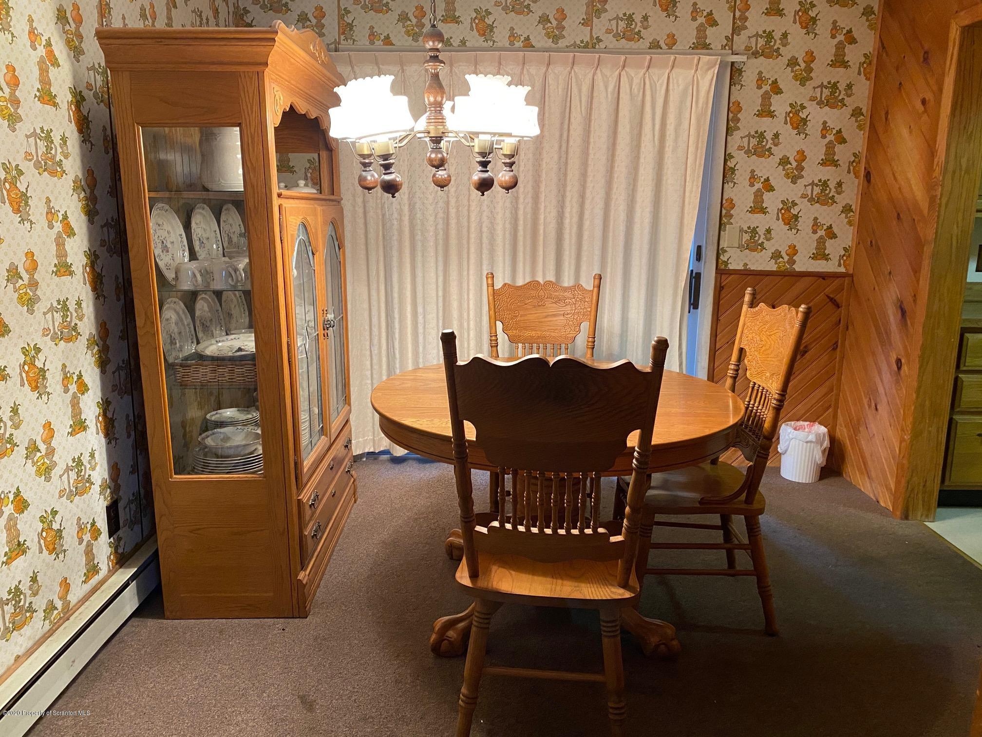 25 Dennis Road Scott Township, PA 18447 - Photo 11 of 43 a dining room with furniture and a chandelier