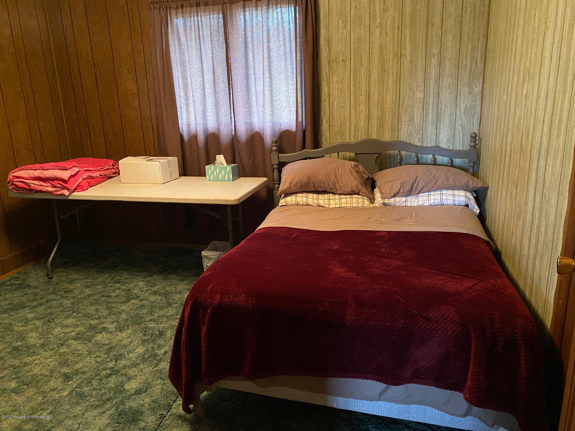 25 Dennis Road Scott Township, PA 18447 - Photo 19 of 43 a bedroom with bed and a table