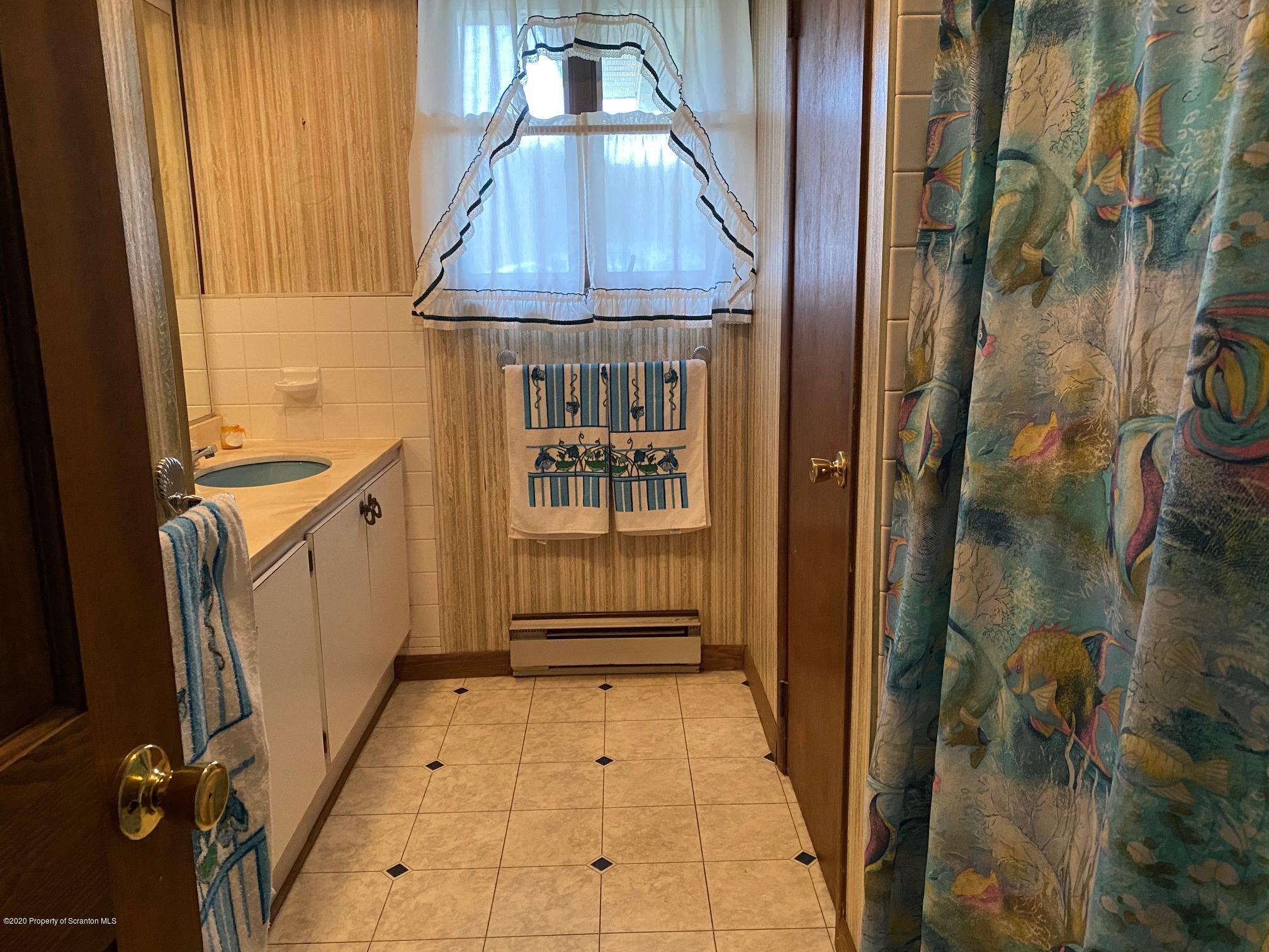 25 Dennis Road Scott Township, PA 18447 - Photo 20 of 43 a bathroom with a tub and shower