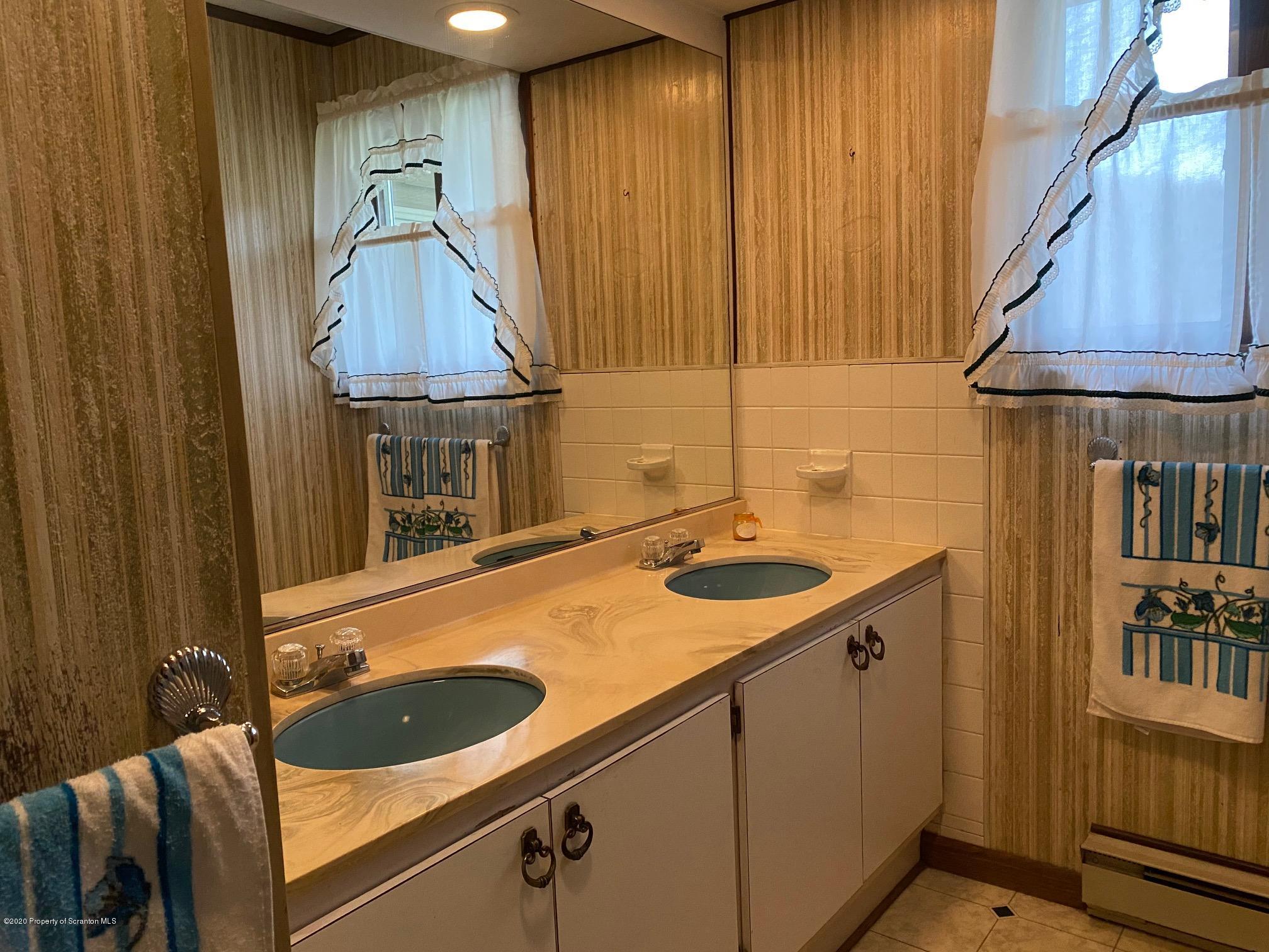 25 Dennis Road Scott Township, PA 18447 - Photo 21 of 43 a kitchen with a sink and a refrigerator