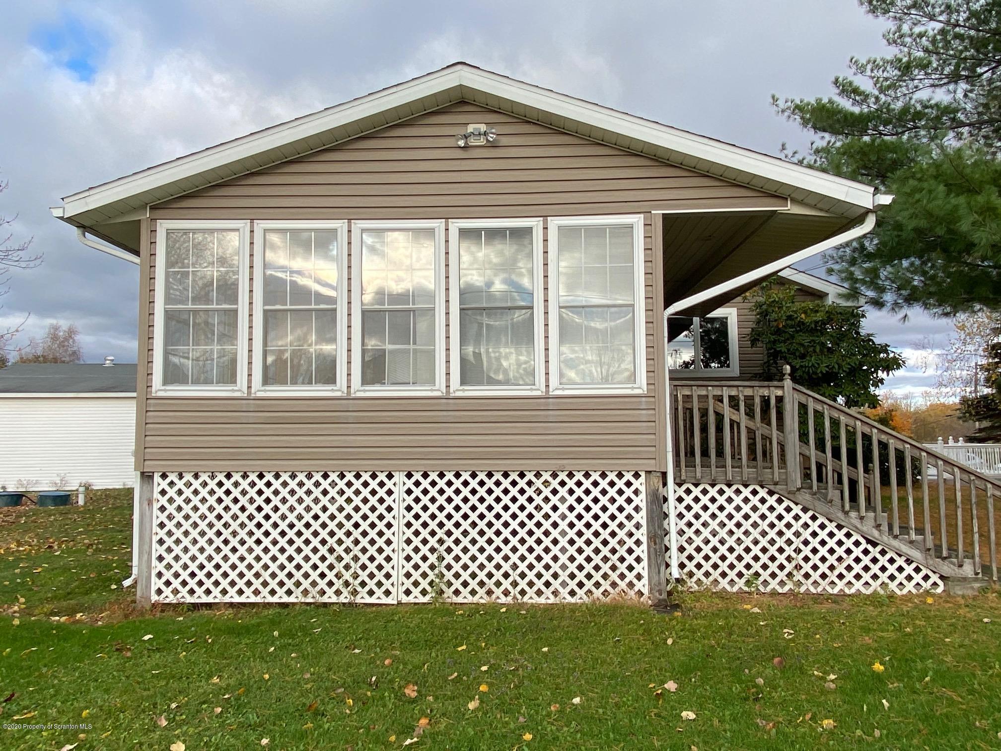 25 Dennis Road Scott Township, PA 18447 - Photo 7 of 43 a front view of a house with a swing