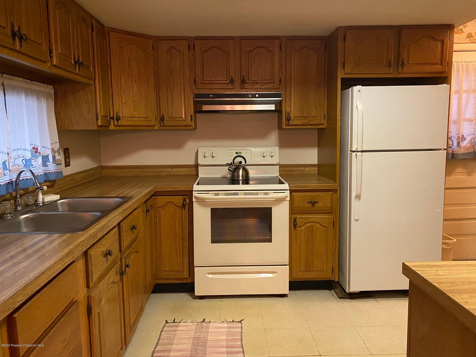 25 Dennis Road Scott Township, PA 18447 - Photo 8 of 43 a kitchen with a sink a stove and refrigerator