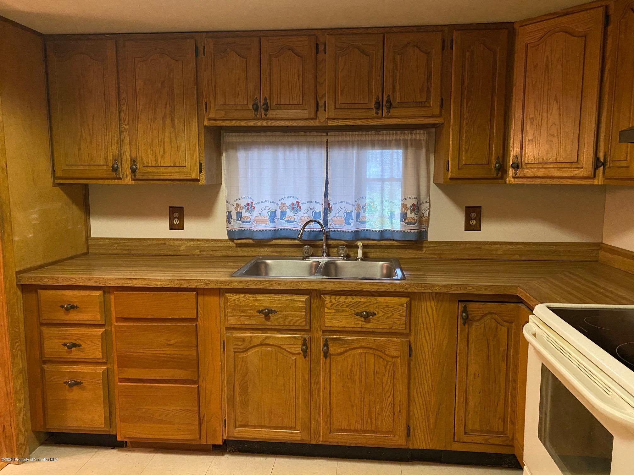 25 Dennis Road Scott Township, PA 18447 - Photo 9 of 43 a kitchen with stainless steel appliances granite countertop wood cabinets and a sink