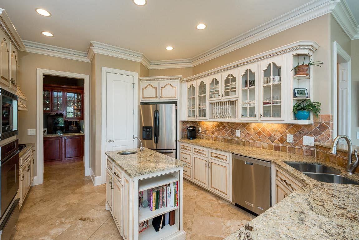 4248 Crowder Road Franklin, TN 37064 - Photo 20 of 29 a kitchen with stainless steel appliances granite countertop a stove and a sink
