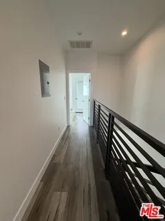 a view of walk in closet with wooden floor