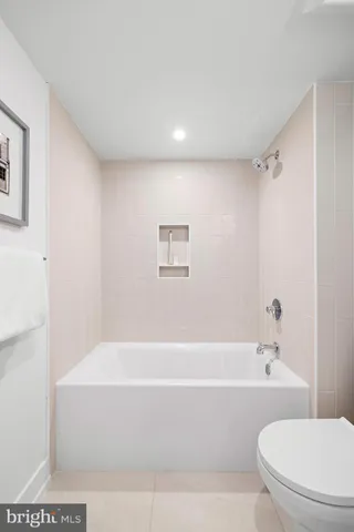 a bathroom with a bathtub and a toilet