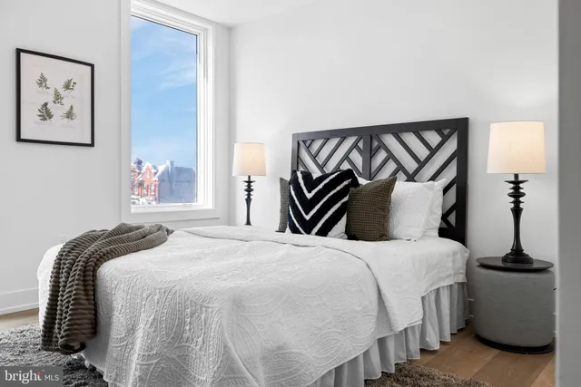 a bedroom with a bed and a painting on the wall