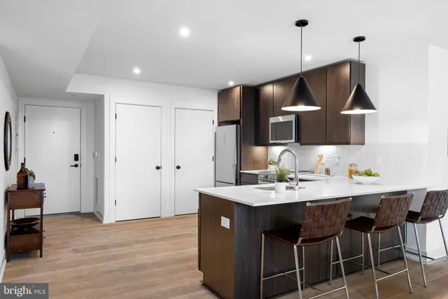 a kitchen with a sink cabinets and wooden floor