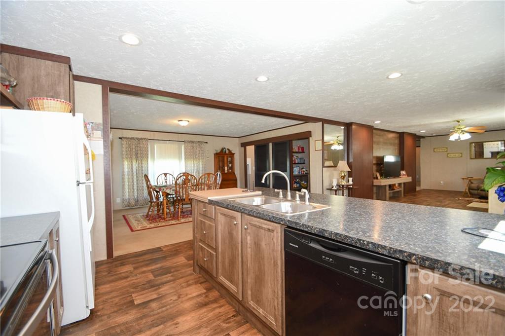 1816 Russell Pope Road Wingate, NC 28174 - Photo 11 of 23 a large kitchen with granite countertop a large counter top appliances and cabinets