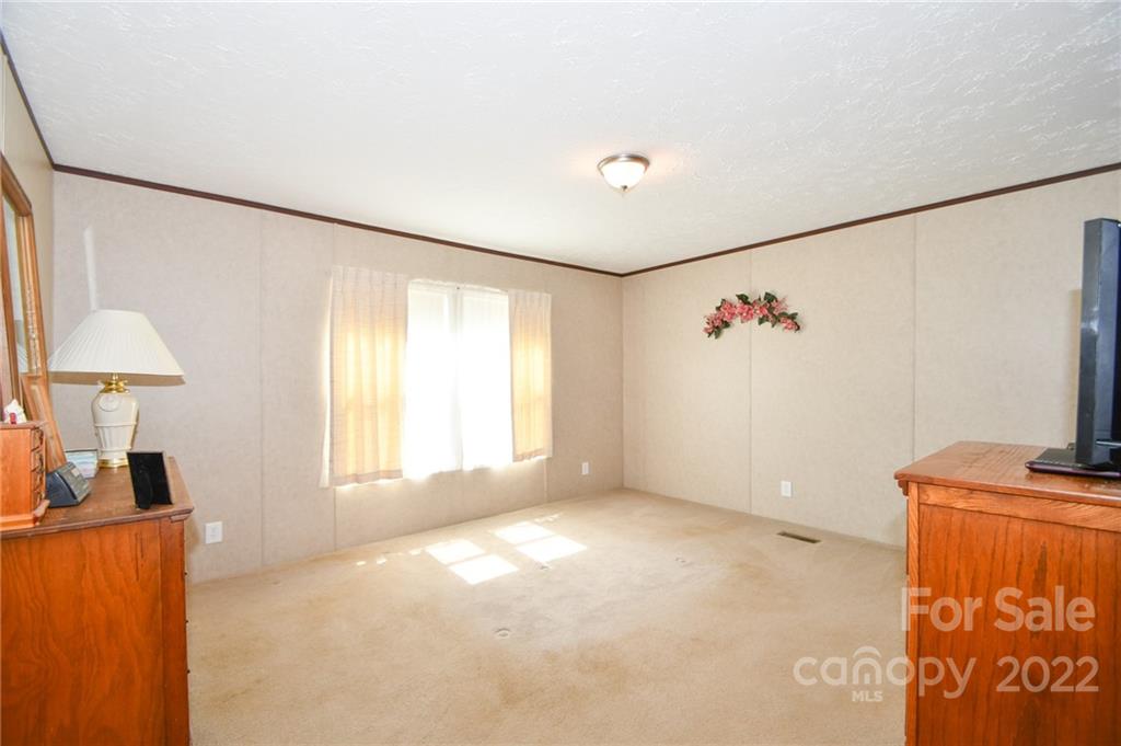 1816 Russell Pope Road Wingate, NC 28174 - Photo 15 of 23 a view of an empty room with a window
