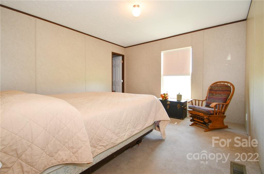 1816 Russell Pope Road Wingate, NC 28174 - Photo 20 of 23 a bedroom with a bed chair and a dresser