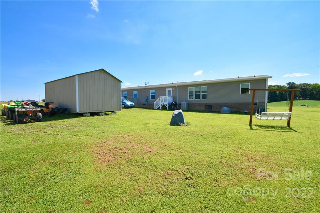 1816 Russell Pope Road Wingate, NC 28174 - Photo 3 of 23 a view of a backyard with a garden and entertaining space