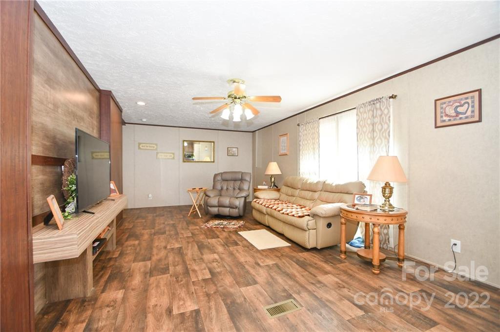 1816 Russell Pope Road Wingate, NC 28174 - Photo 6 of 23 a living room with furniture and a chandelier