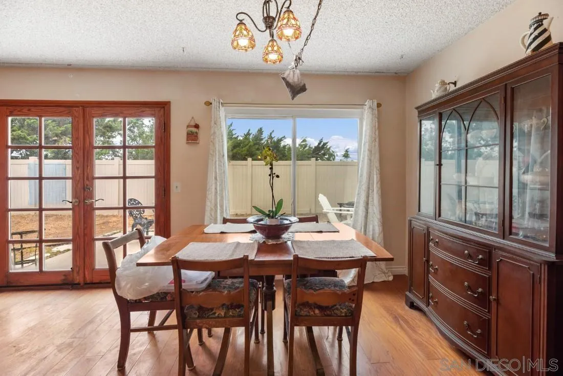 894 Coldstream Drive El Cajon, CA 92020 - Photo 16 of 30 a view of a dining room with furniture large windows and wooden floor