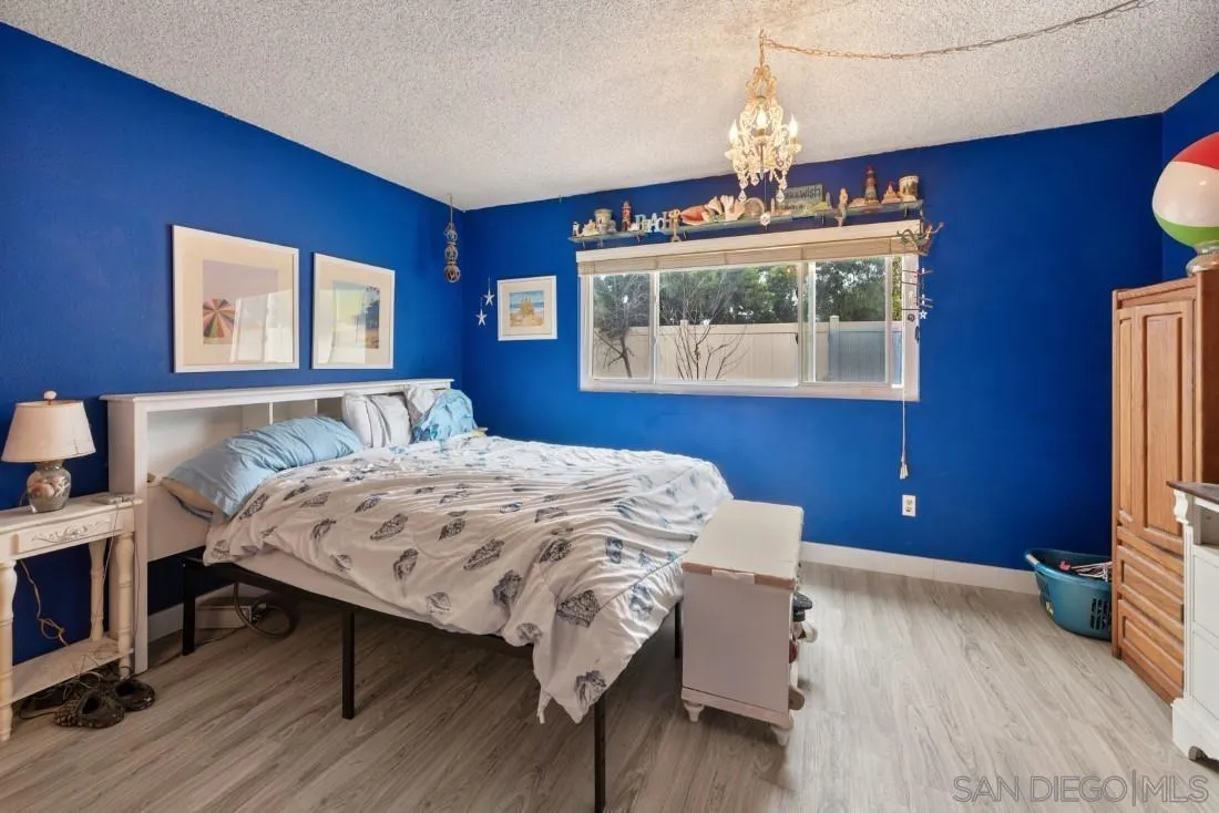 894 Coldstream Drive El Cajon, CA 92020 - Photo 20 of 30 a bedroom with a bed and a chandelier