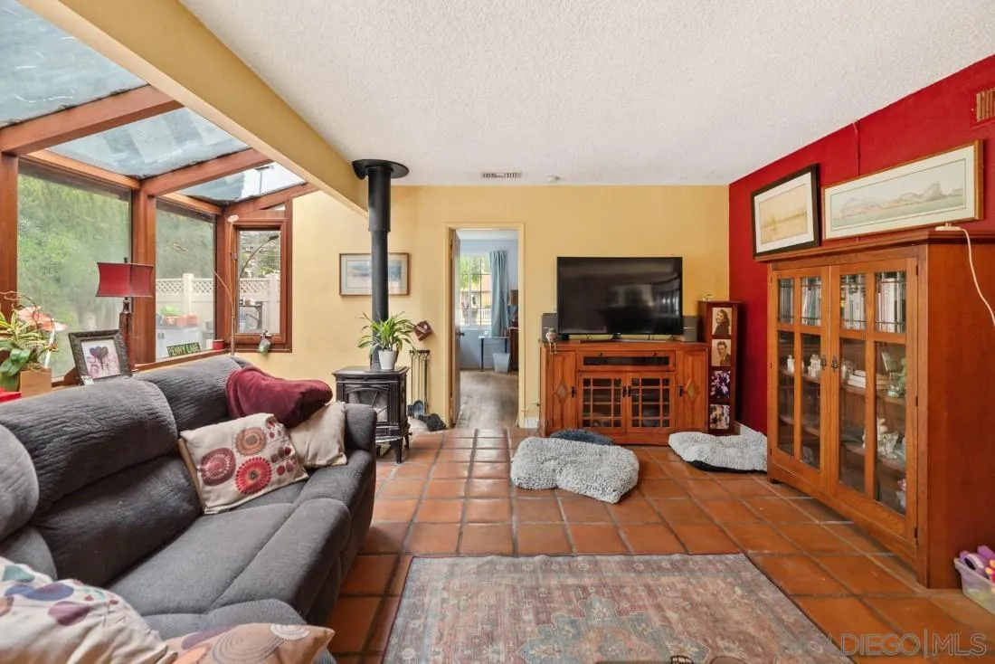 894 Coldstream Drive El Cajon, CA 92020 - Photo 9 of 30 a living room with furniture a flat screen tv and a floor to ceiling window