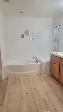 a spacious bathroom with a bathtub and sink