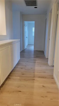 a view of hallway with wooden floor