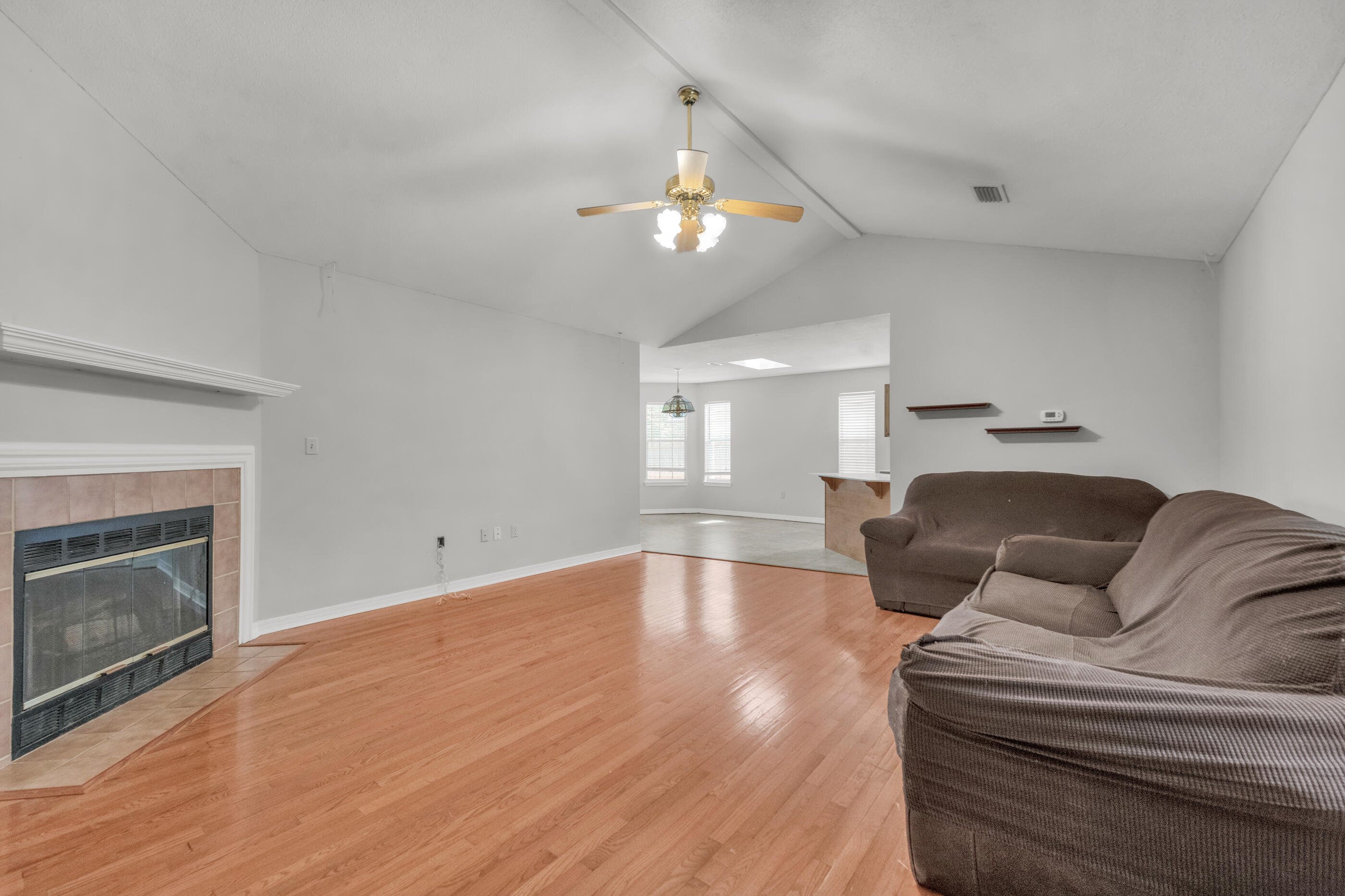 120 Wright Circle Niceville, FL 32578 - Photo 4 of 19 a living room with furniture a fireplace and a ceiling fan