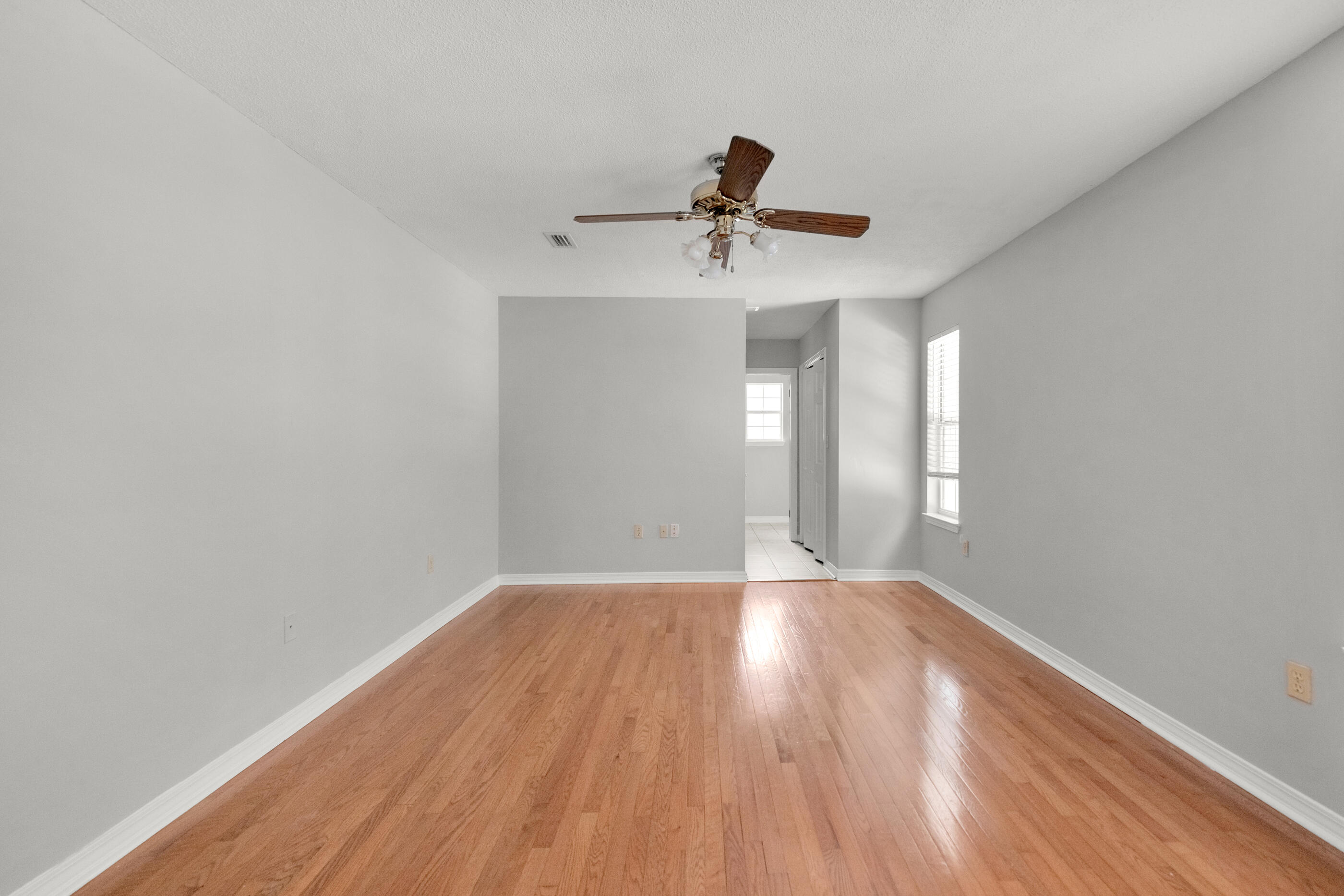 120 Wright Circle Niceville, FL 32578 - Photo 10 of 19 a view of empty room with wooden floor and fan