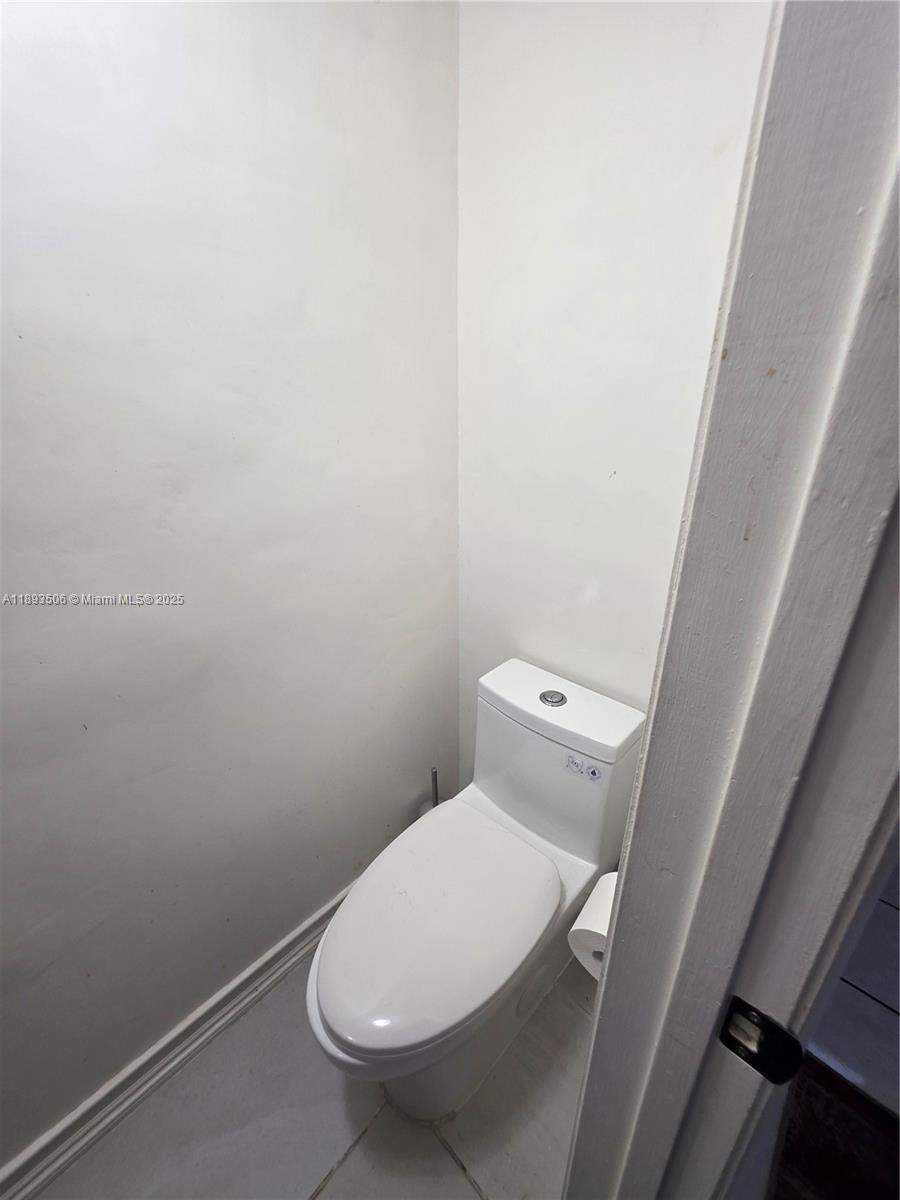 8000 Southwest 152nd Avenue, Unit 115 Miami, FL 33193 - Photo 9 of 33 a white toilet sitting next to a white cabinet