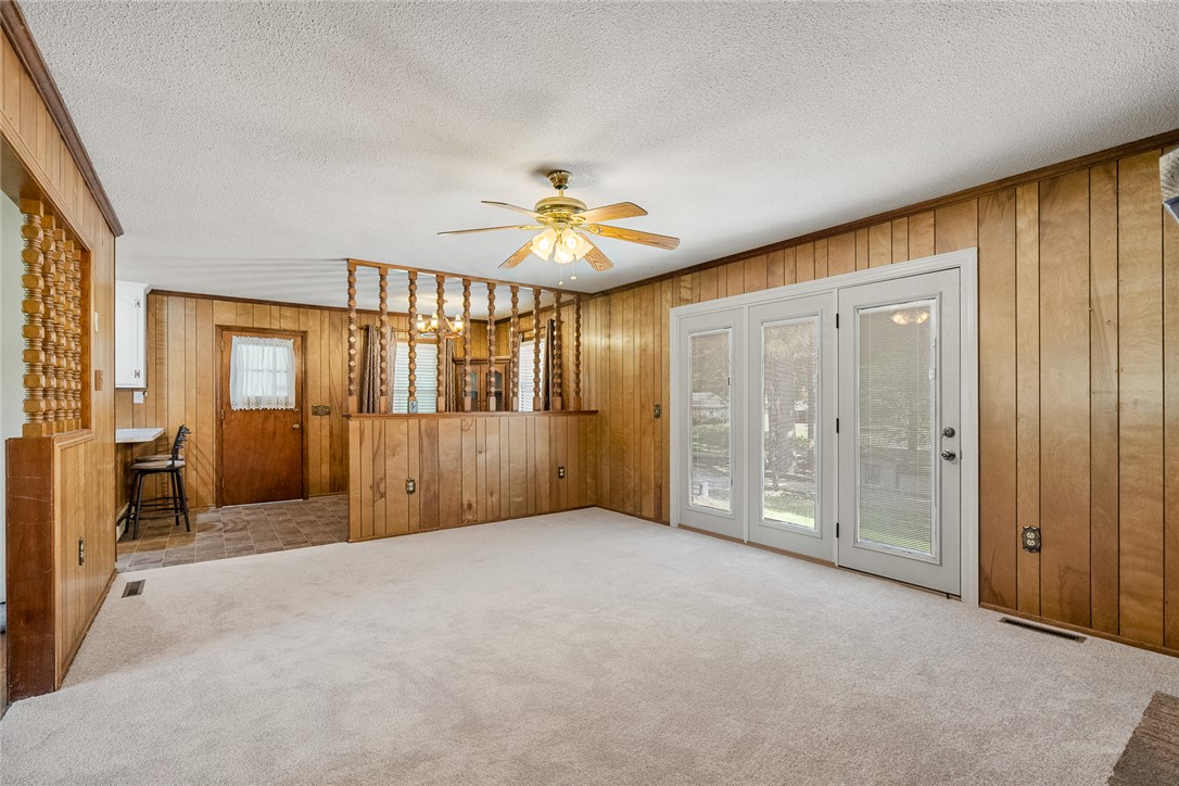 2101 Old Spring Drive Anderson, SC 29625 - Photo 6 of 36 A relaxed living area boasts a ceiling fan, plush carpeting, and direct access to the outdoors through glass French doors.