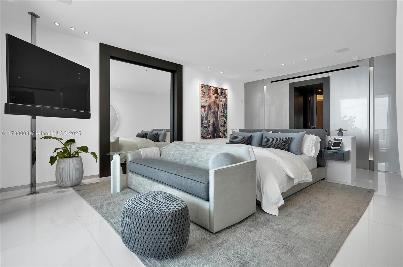 125 Ocean Drive, Unit PH Miami Beach, FL 33139 - Photo 21 of 56 a spacious bedroom with a bed and a flat screen tv
