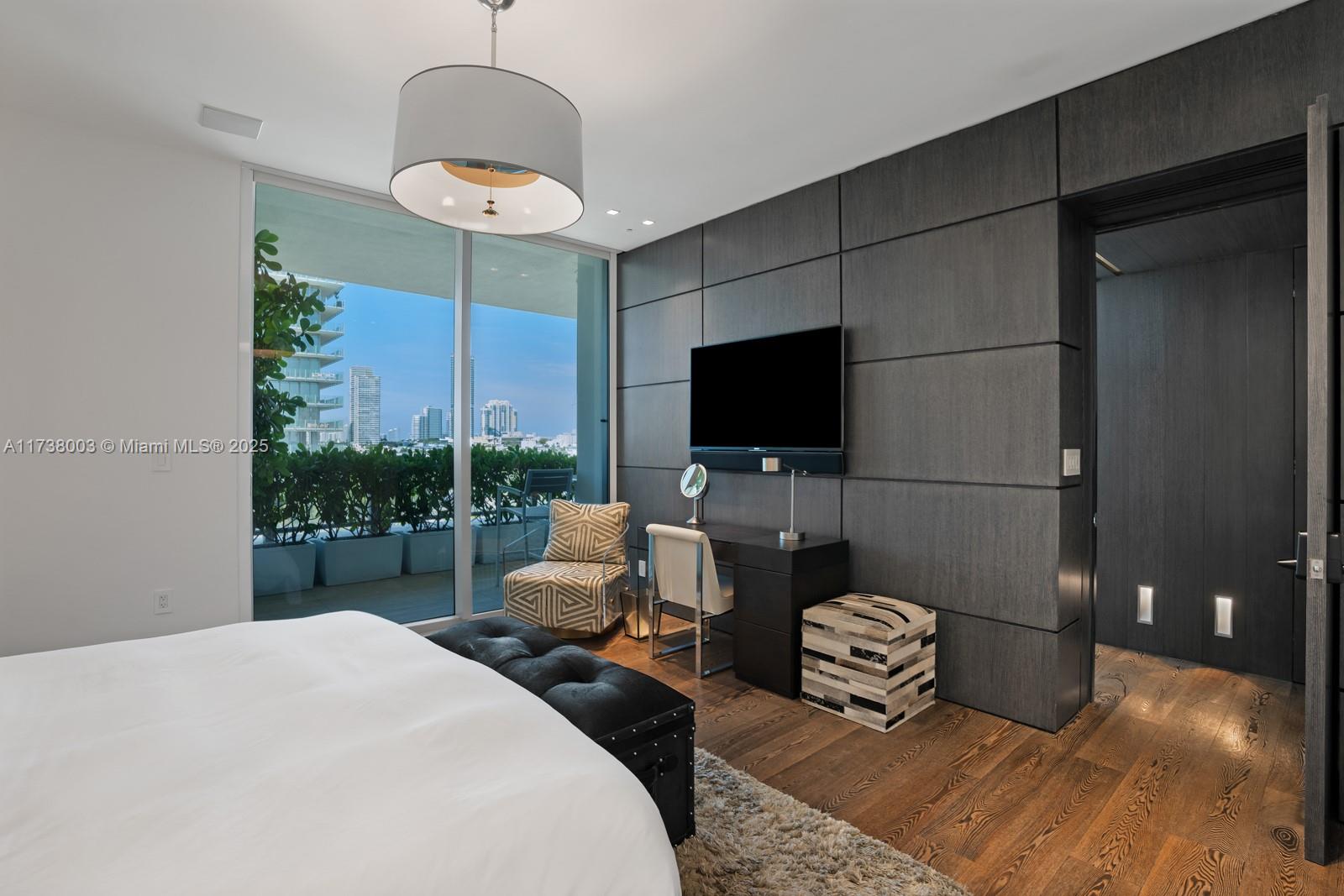 125 Ocean Drive, Unit PH Miami Beach, FL 33139 - Photo 29 of 56 a bedroom with a bed and a flat screen tv