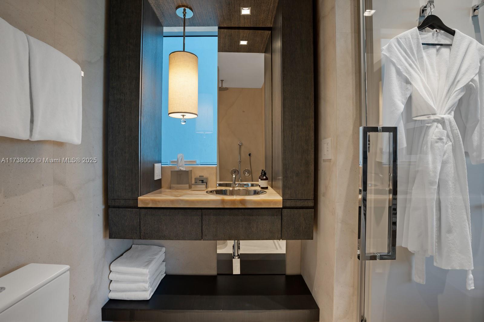 125 Ocean Drive, Unit PH Miami Beach, FL 33139 - Photo 30 of 56 a bathroom with a sink a light fixture and a mirror