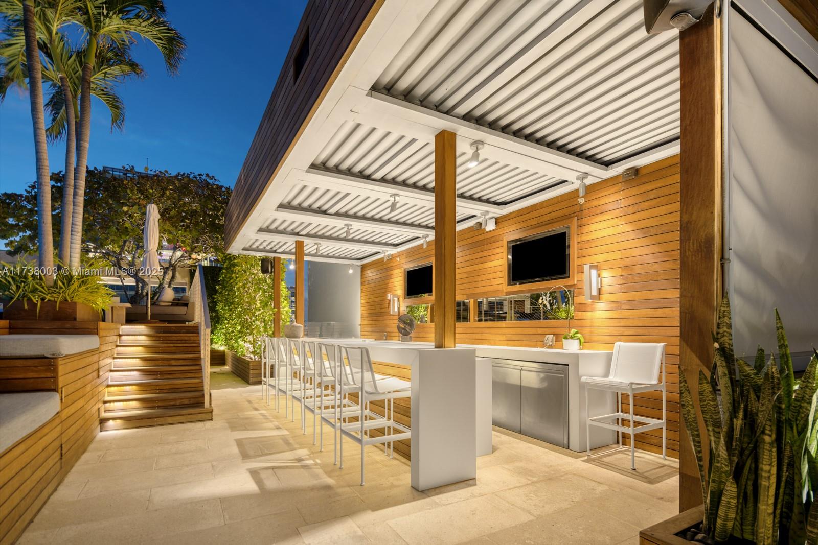 125 Ocean Drive, Unit PH Miami Beach, FL 33139 - Photo 35 of 56 a view of a patio with couches table and chairs and potted plants