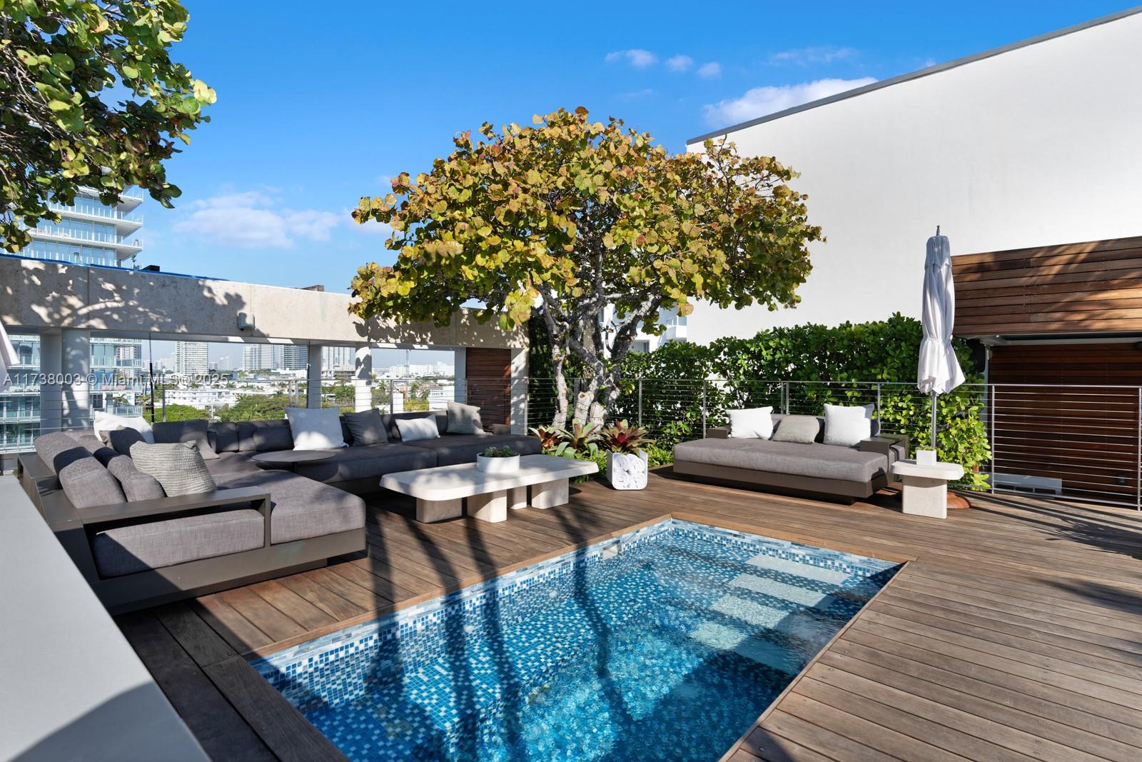 125 Ocean Drive, Unit PH Miami Beach, FL 33139 - Photo 43 of 56 a view of a patio with couches table and chairs with wooden floor and fence