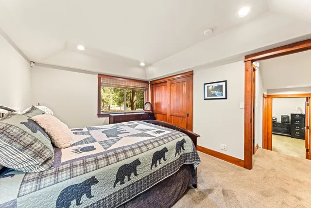 a bedroom with a bed next to a window