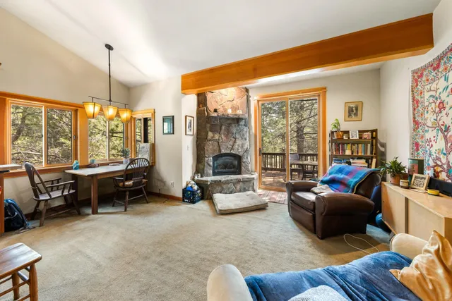 a living room with furniture and floor to ceiling windows