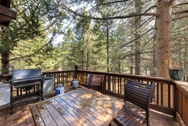 a view of a balcony with wooden floor and outdoor seating