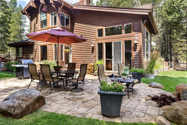 a view of a house with backyard sitting area and garden