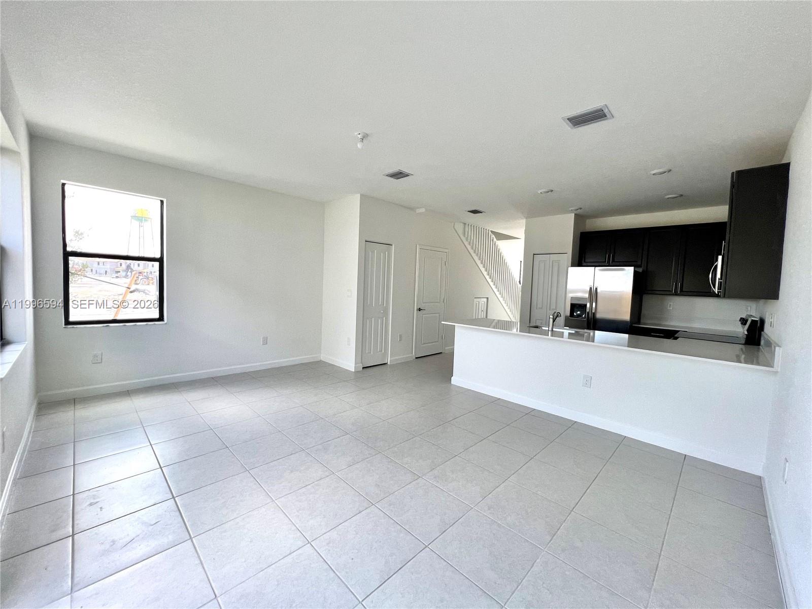 23373 Southwest 129th Path, Unit 23373 Homestead, FL 33032 - Photo 11 of 18 a view of an empty room with a window