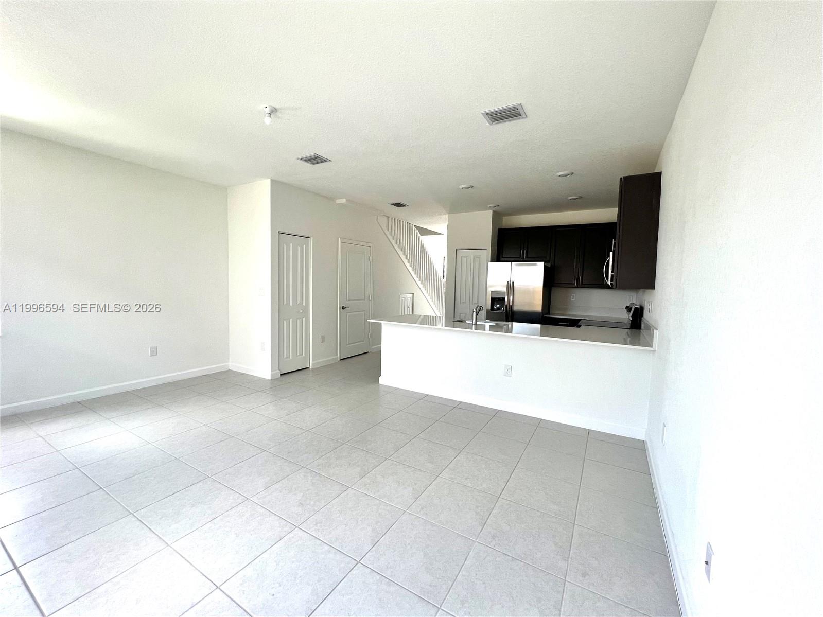 23373 Southwest 129th Path, Unit 23373 Homestead, FL 33032 - Photo 12 of 18 a view of a kitchen with a sink and a refrigerator