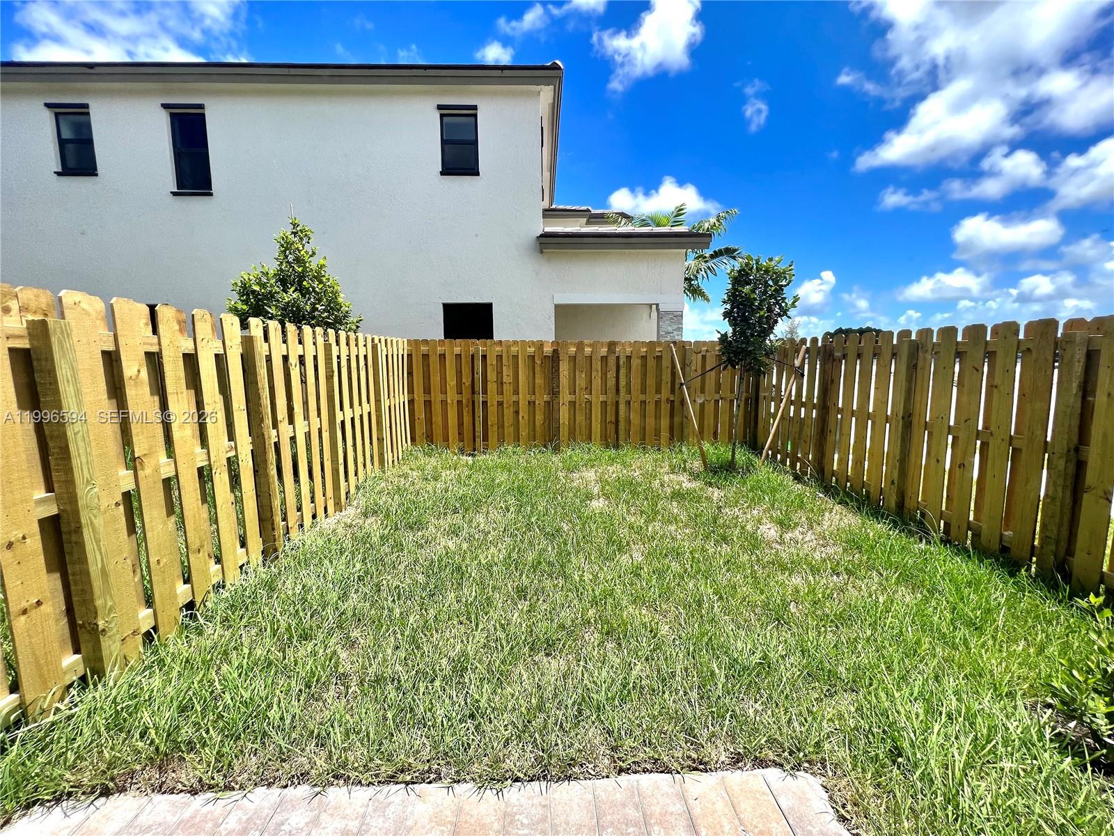 23373 Southwest 129th Path, Unit 23373 Homestead, FL 33032 - Photo 18 of 18 a view of a house with a small yard