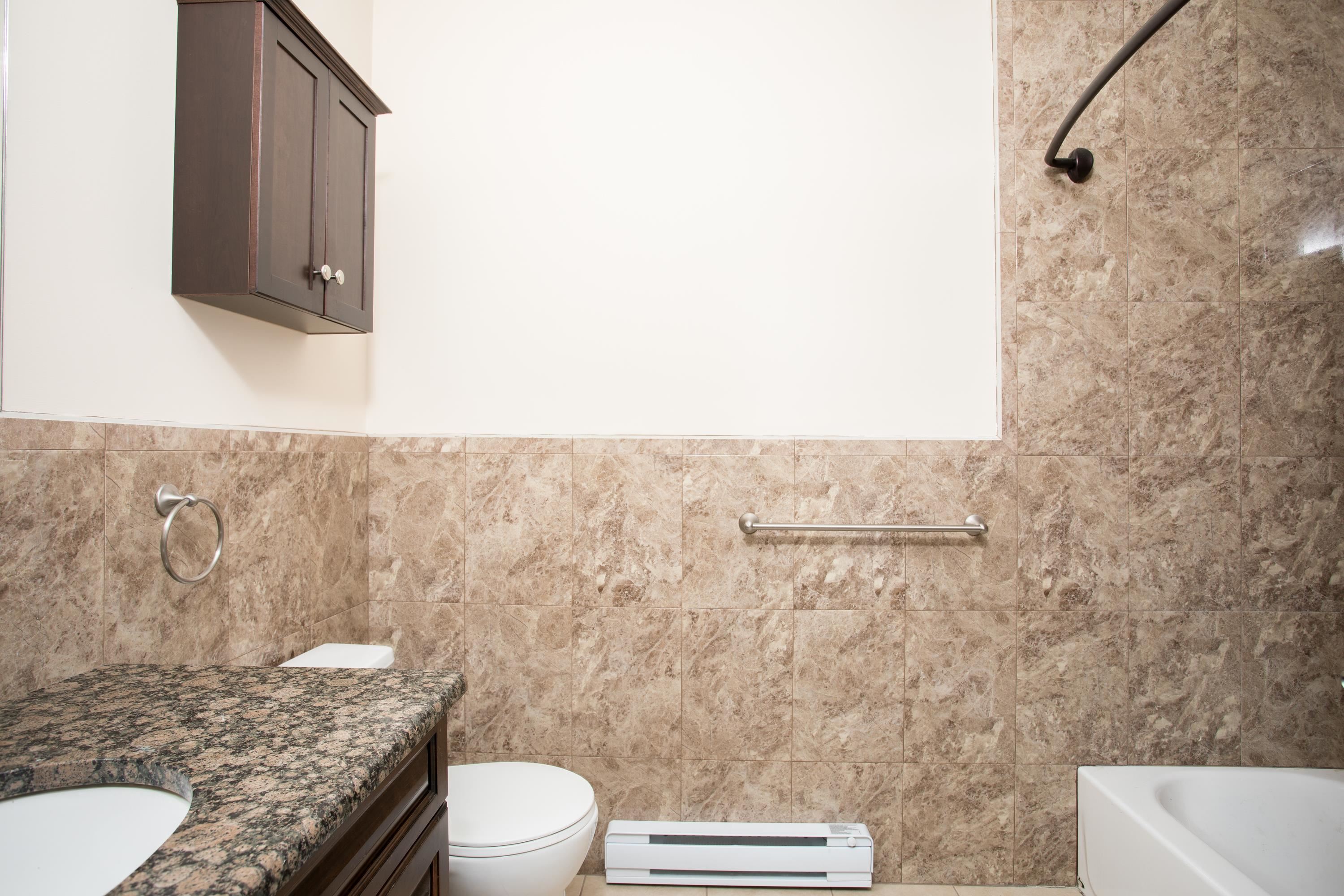 6111 Fillmore Place, Unit 306 West New York, NJ 07093 - Photo 14 of 27 a bathroom with a granite countertop toilet and a sink