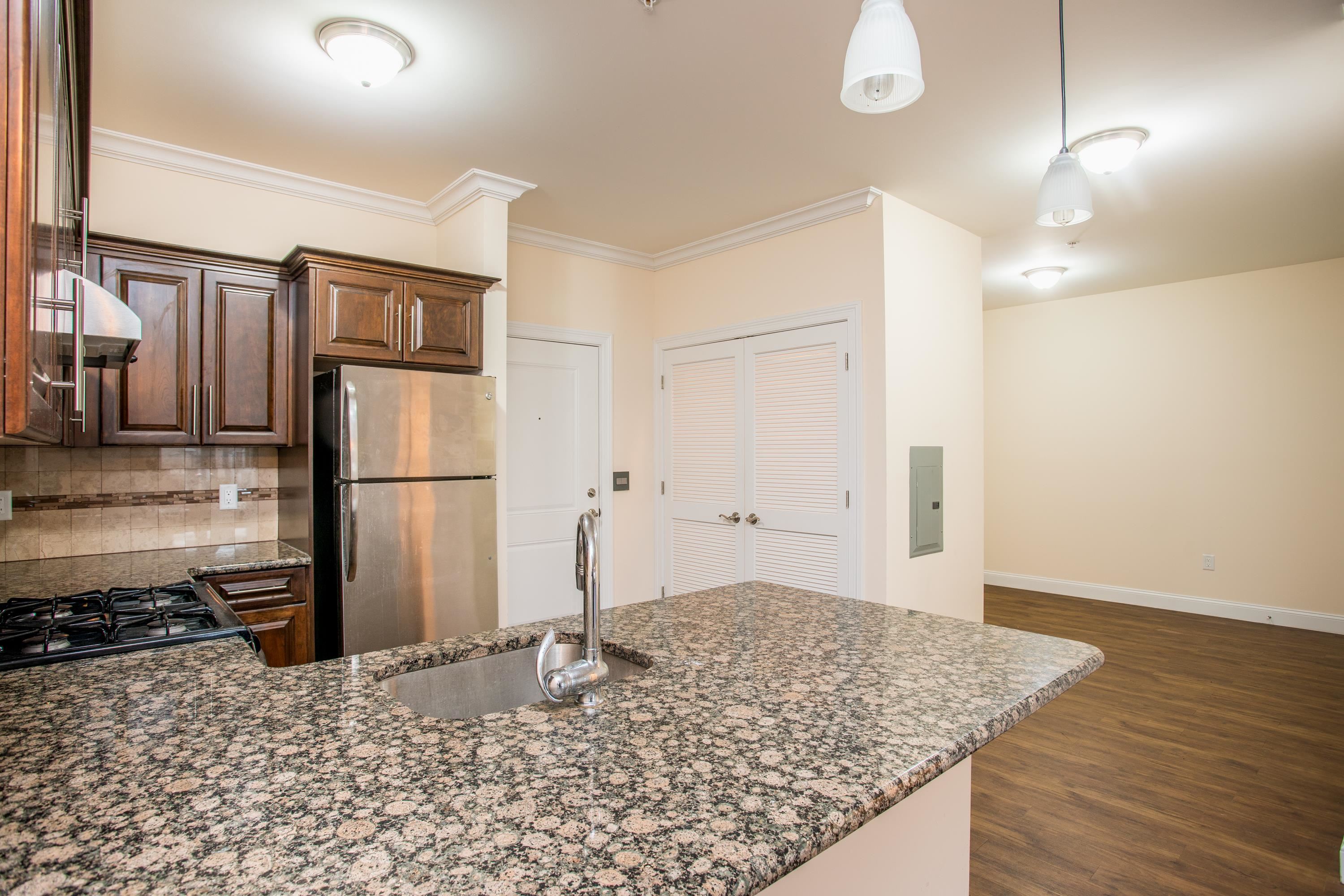 6111 Fillmore Place, Unit 306 West New York, NJ 07093 - Photo 16 of 27 a kitchen with a sink refrigerator and microwave