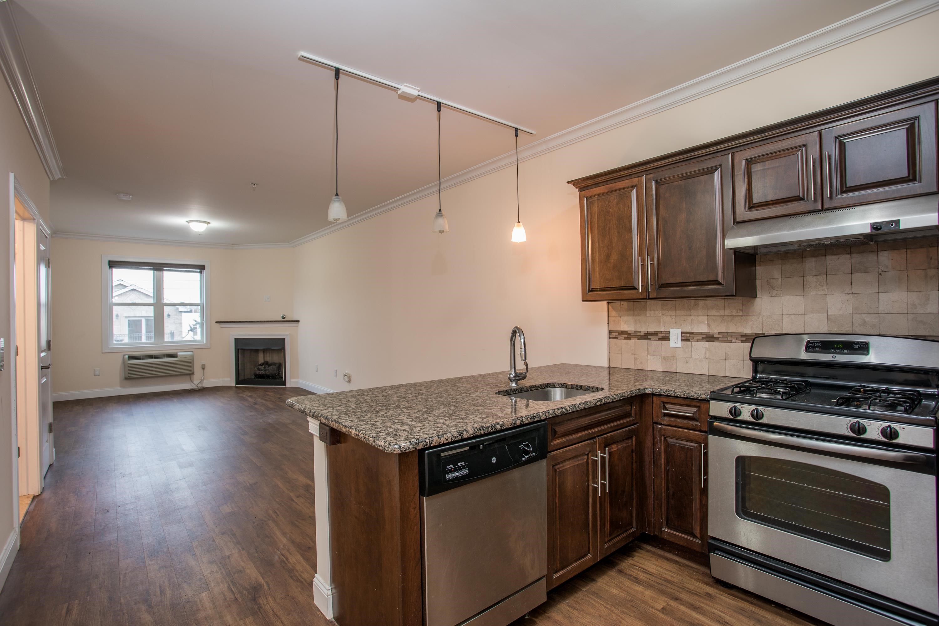 6111 Fillmore Place, Unit 306 West New York, NJ 07093 - Photo 17 of 27 a kitchen with granite countertop a stove and a sink