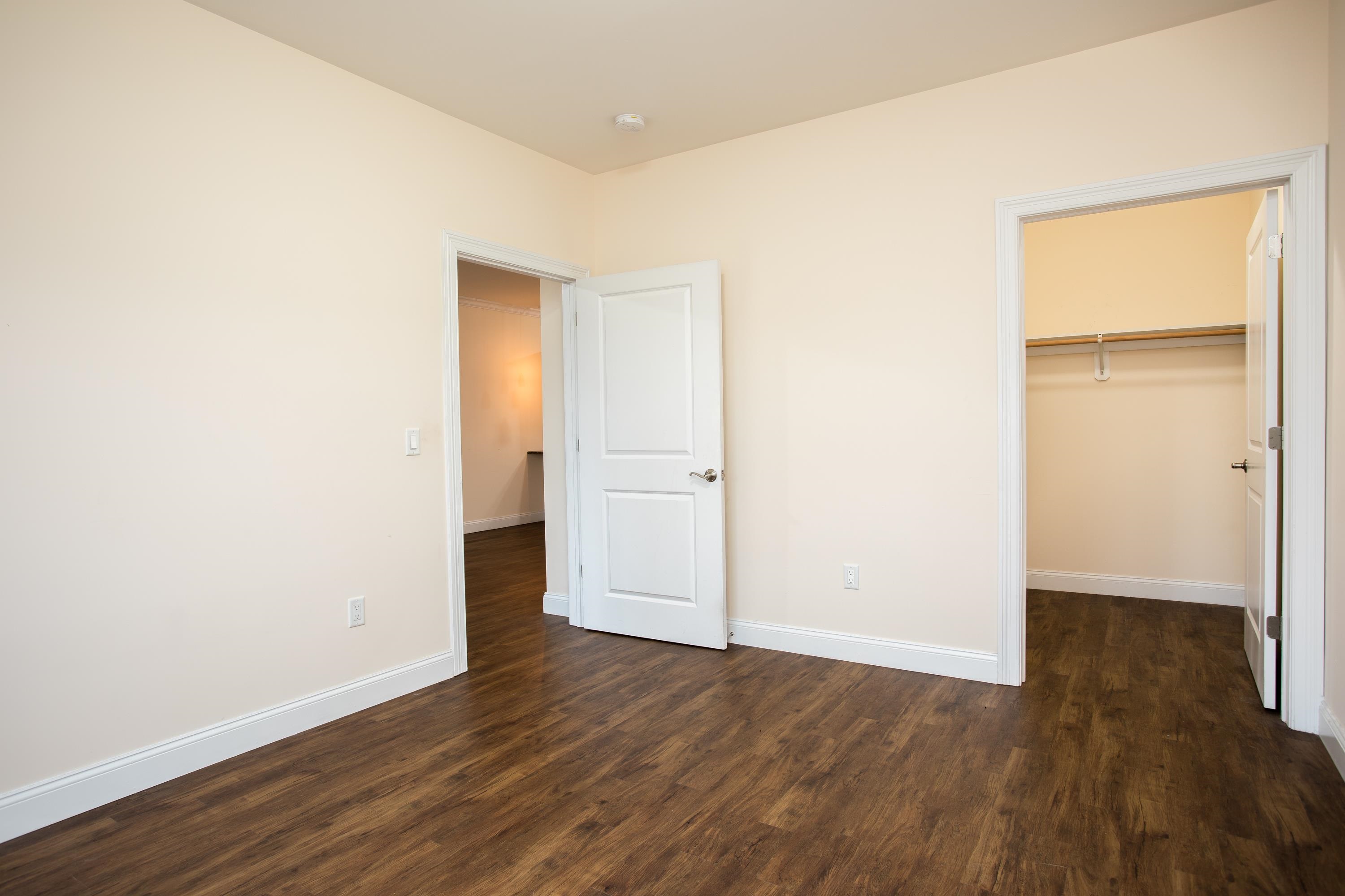 6111 Fillmore Place, Unit 306 West New York, NJ 07093 - Photo 20 of 27 an empty room with wooden floor & cabinet and a window