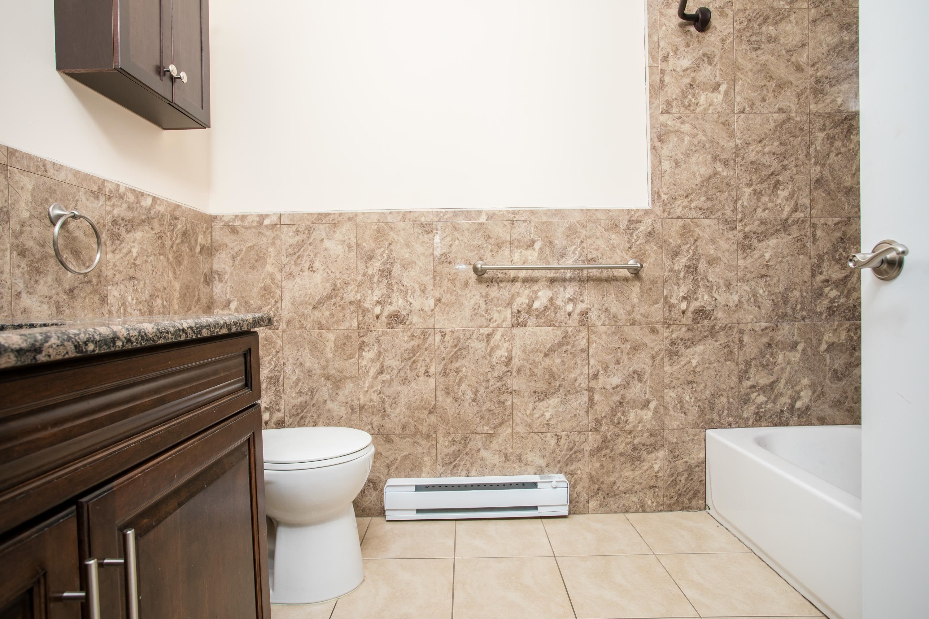 6111 Fillmore Place, Unit 306 West New York, NJ 07093 - Photo 23 of 27 a bathroom with a toilet and a bathtub